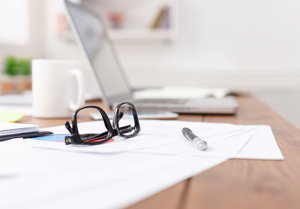 laptop and eyeglasses on table