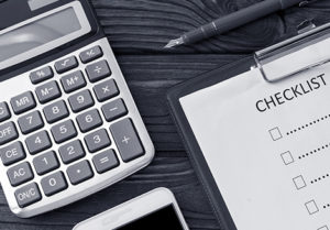 Clipboard checklist, calculator and mobile phone